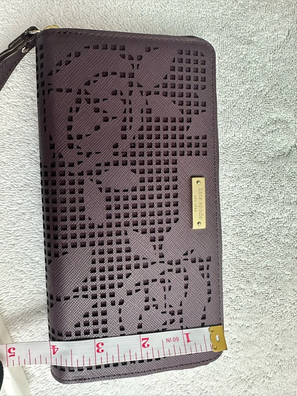 kate spade plum perforated floral zip phone wristlet